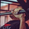 close up of a man doing pull-ups