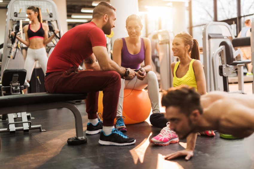 Group of young happy people in a health club.