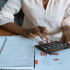 One woman using a calculator.